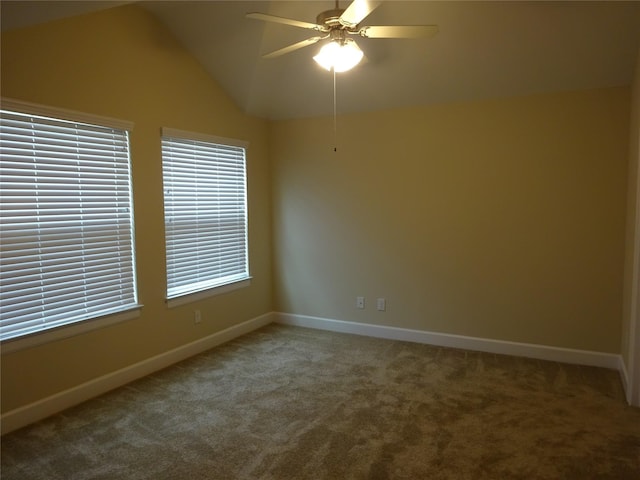 empty room featuring carpet flooring, ceiling fan, and vaulted ceiling