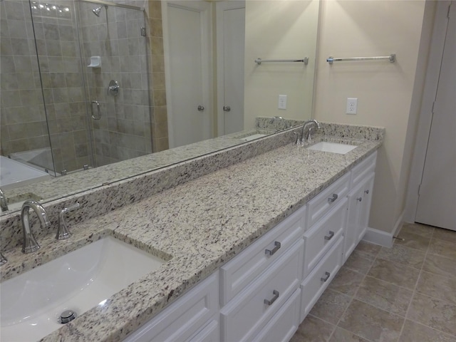 bathroom featuring vanity and a shower with door