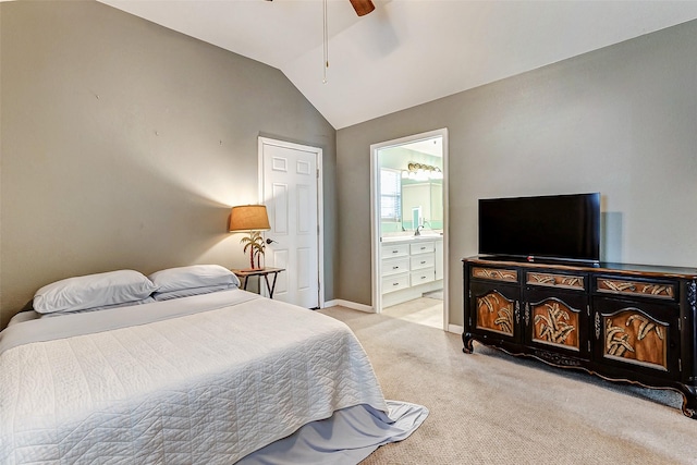 carpeted bedroom with ensuite bathroom, ceiling fan, and vaulted ceiling