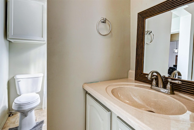 bathroom with tile patterned floors, vanity, and toilet