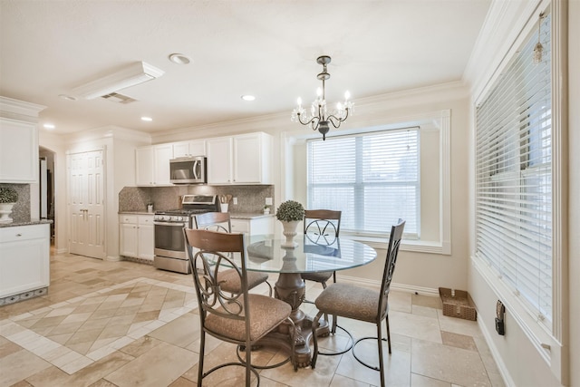 dining room with a chandelier and ornamental molding