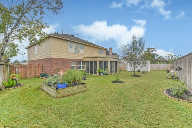 rear view of house with a lawn and a sunroom