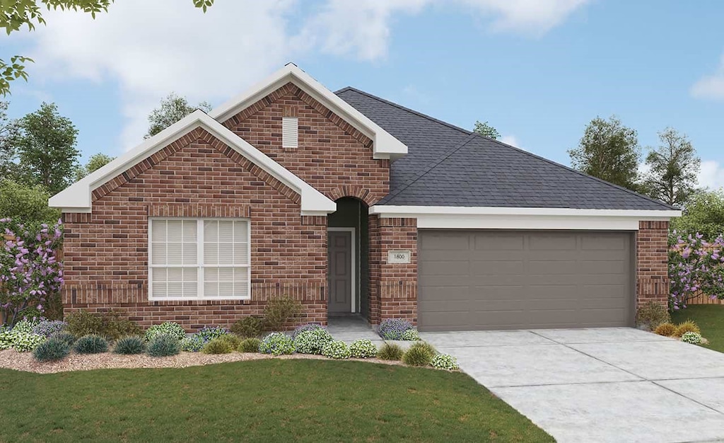 view of front of house featuring a garage and a front lawn