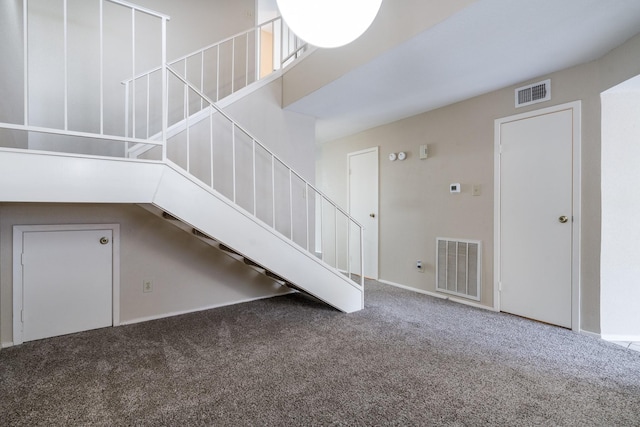 staircase featuring carpet flooring