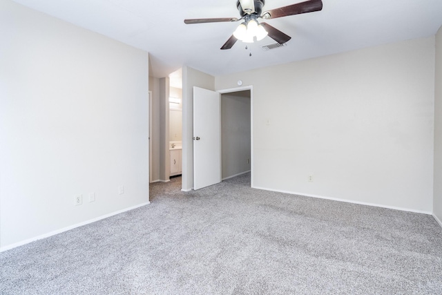 carpeted spare room featuring ceiling fan