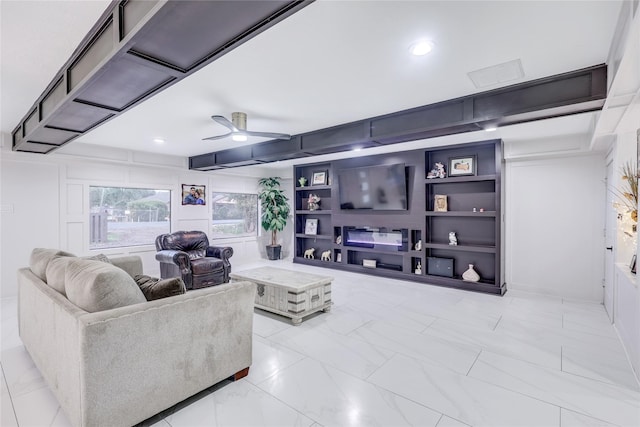 living room featuring ceiling fan and built in features