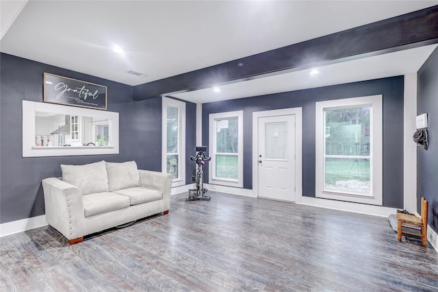 living room with beamed ceiling and wood-type flooring