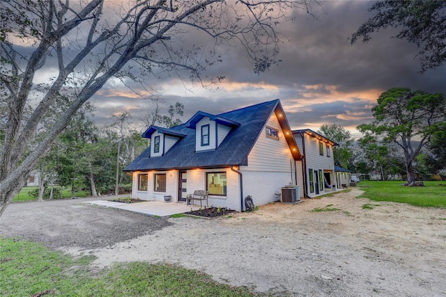 cape cod home with central AC and a patio