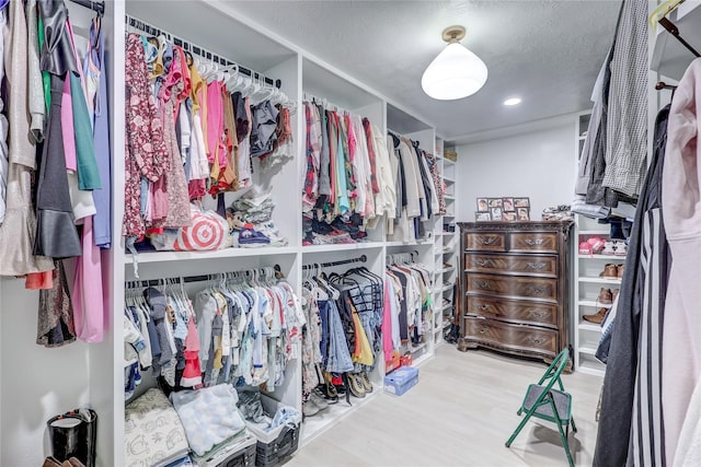 walk in closet with wood-type flooring