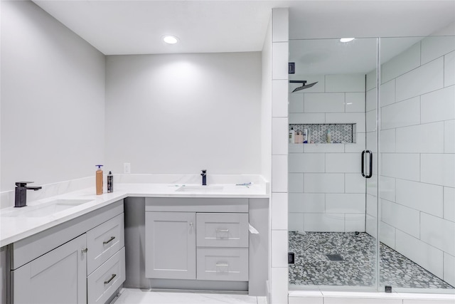 bathroom featuring vanity and a shower with shower door