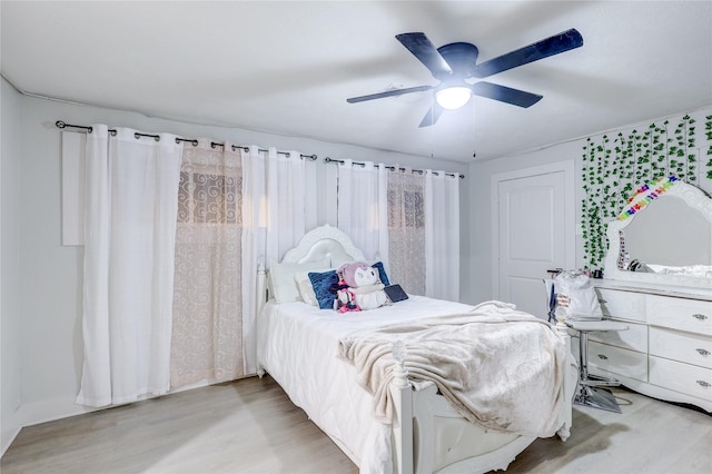 bedroom with ceiling fan and light hardwood / wood-style floors