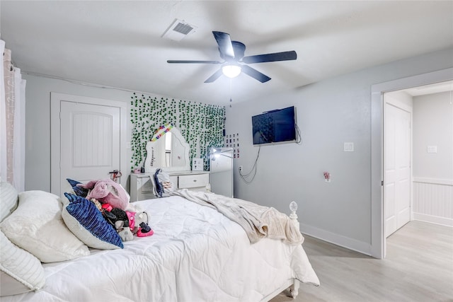 bedroom with ceiling fan and light hardwood / wood-style flooring