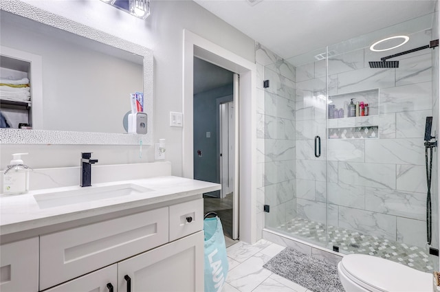 bathroom featuring vanity, toilet, and walk in shower