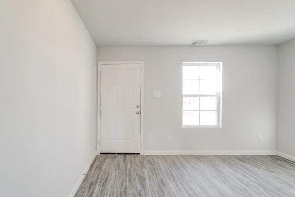 spare room with light wood-type flooring