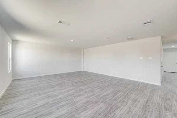 spare room with light hardwood / wood-style floors