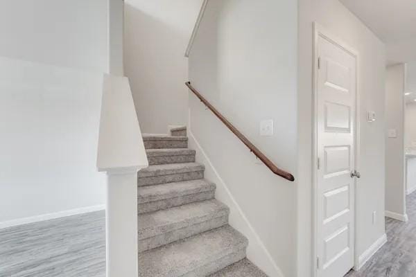 stairway with hardwood / wood-style flooring