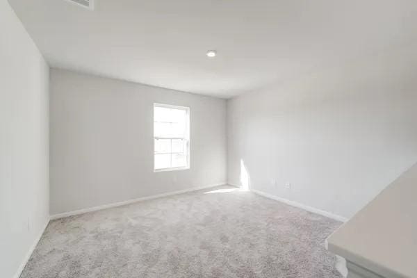 spare room with light carpet