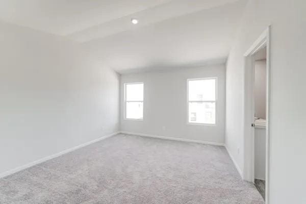 spare room featuring light colored carpet