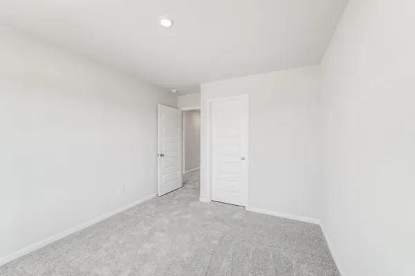 spare room with light carpet