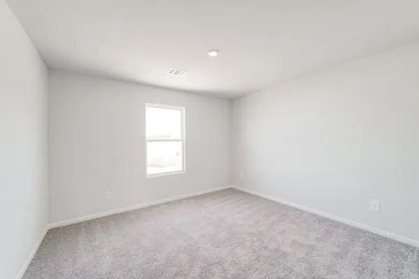 empty room with light colored carpet