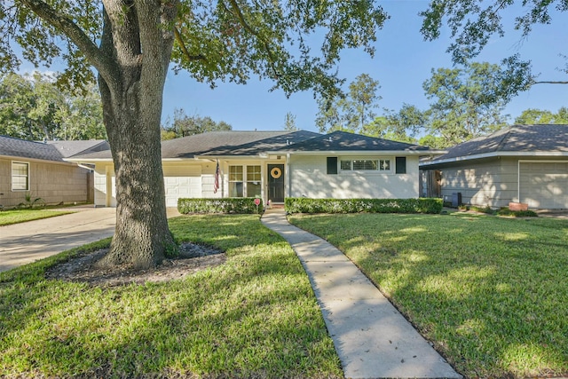 ranch-style house featuring a front lawn and a garage