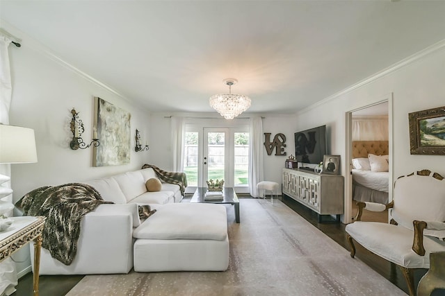 living room featuring crown molding and a chandelier