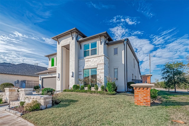 view of front facade with a front yard and a garage