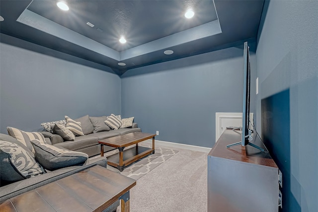 carpeted living room featuring a raised ceiling