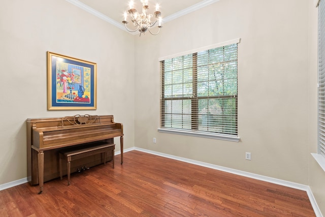 misc room featuring hardwood / wood-style flooring, crown molding, and a notable chandelier