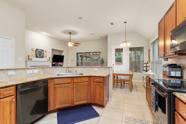 kitchen featuring ceiling fan with notable chandelier, sink, light stone countertops, appliances with stainless steel finishes, and tasteful backsplash