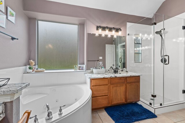 bathroom featuring tile patterned flooring, vanity, and plus walk in shower