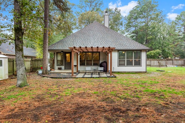 rear view of property with a patio area, a pergola, and a yard