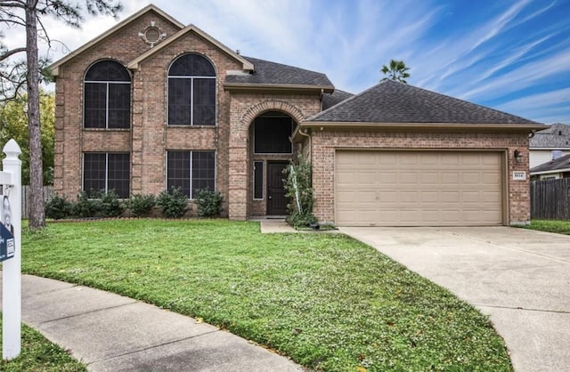 view of front of home featuring a garage and a front lawn