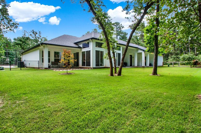 rear view of house with a lawn