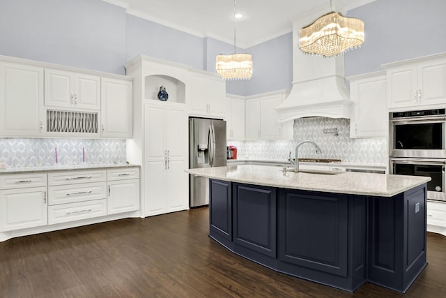 kitchen with white cabinets, stainless steel appliances, hanging light fixtures, sink, and an inviting chandelier