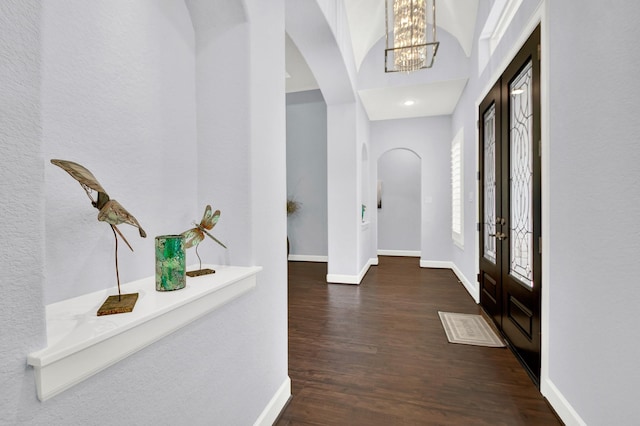 entryway featuring an inviting chandelier, french doors, and dark hardwood / wood-style floors