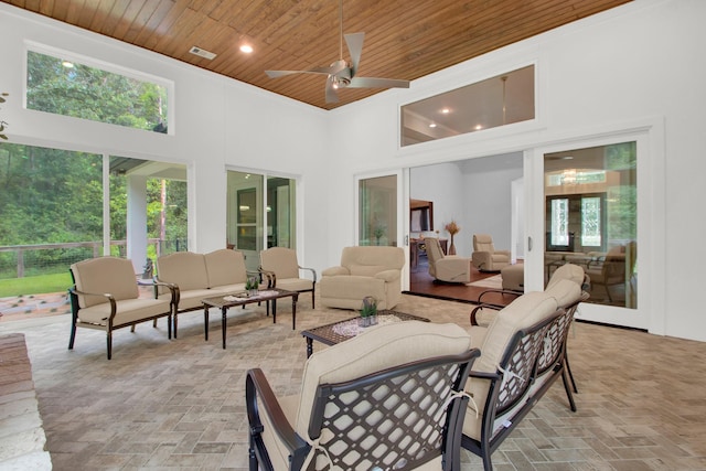 sunroom / solarium with french doors, ceiling fan, and wood ceiling