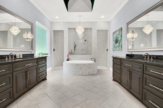 bathroom with a relaxing tiled tub, crown molding, vanity, tile patterned floors, and a notable chandelier