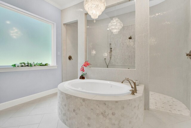 bathroom featuring shower with separate bathtub, tile patterned floors, ornamental molding, and a notable chandelier