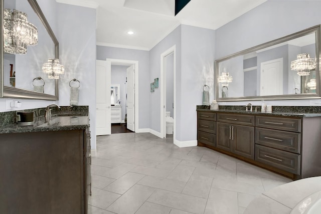 bathroom featuring an inviting chandelier, crown molding, and vanity