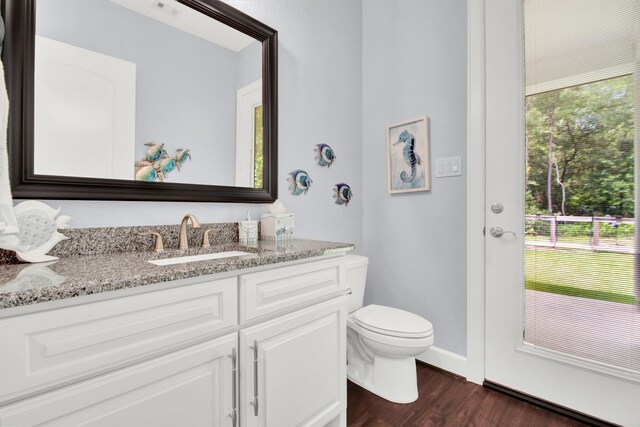 bathroom featuring hardwood / wood-style floors, vanity, and toilet