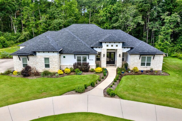 view of front of home with french doors and a front lawn