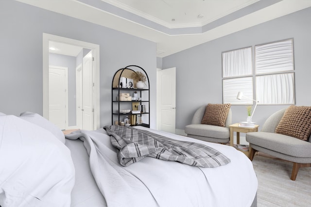 bedroom with a raised ceiling and crown molding