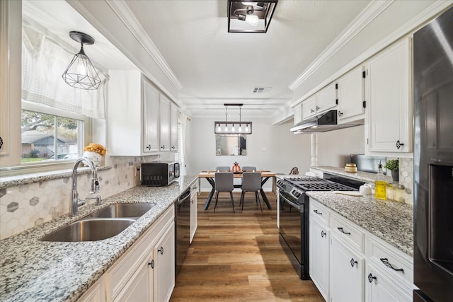 kitchen featuring pendant lighting, sink, white cabinetry, and black appliances