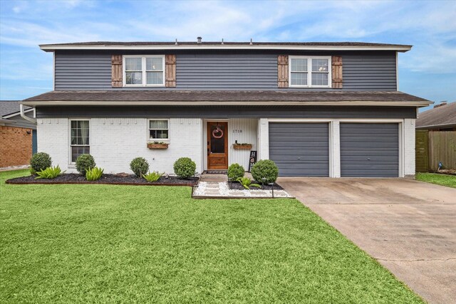 view of front of house featuring a garage and a front yard