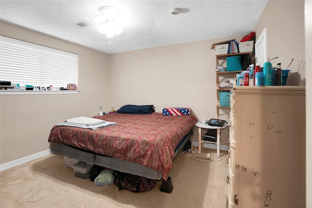 carpeted bedroom featuring a textured ceiling