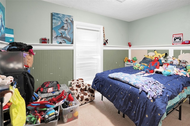 bedroom featuring carpet flooring and a textured ceiling