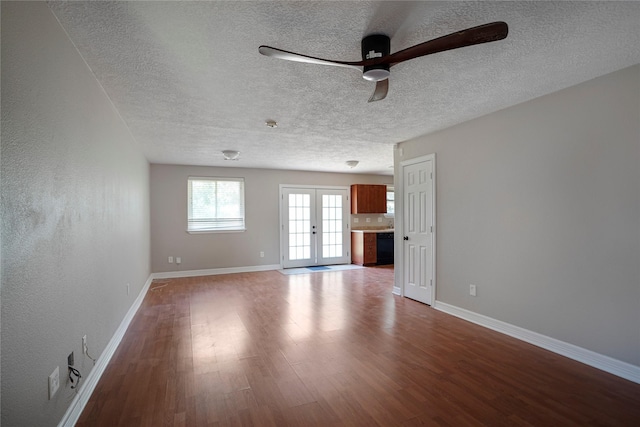 506 Brendon Park Ln, Friendswood, TX 77546 - unfurnished living room with a ceiling fan, wood finished floors, a textured ceiling, baseboards, and french doors