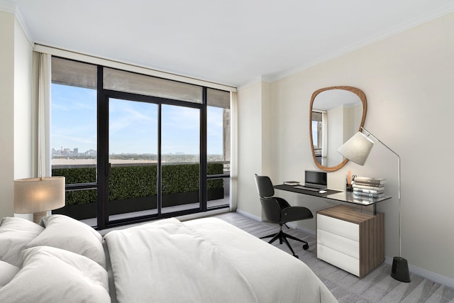 carpeted bedroom with floor to ceiling windows, access to exterior, and crown molding