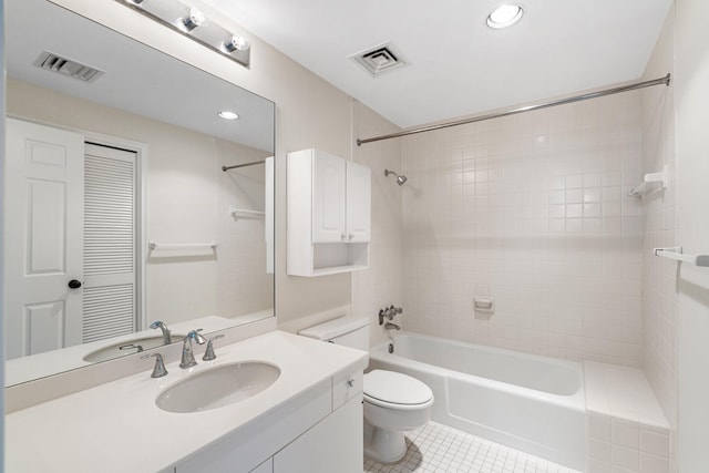 full bathroom featuring toilet, vanity, tile patterned floors, and tiled shower / bath